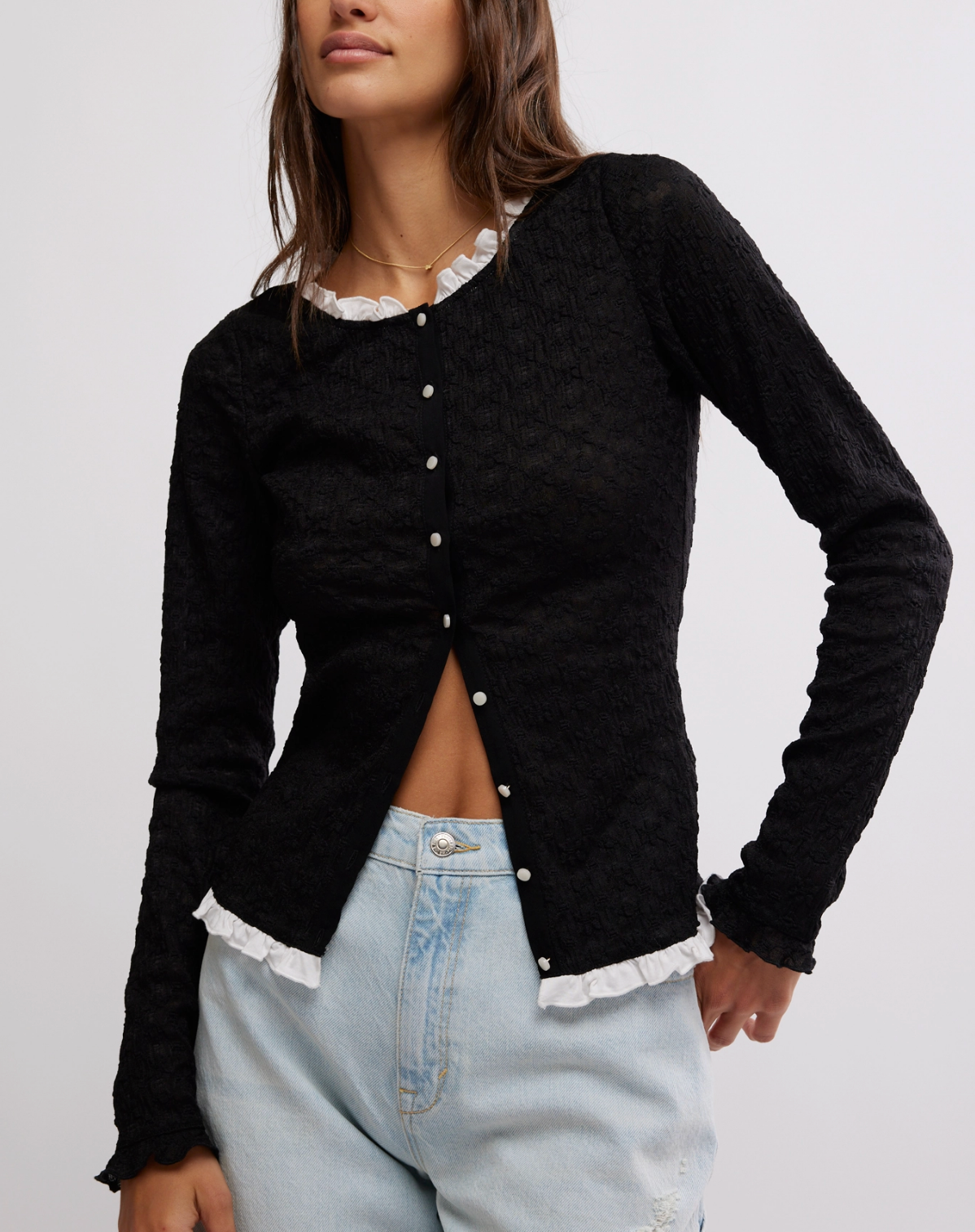 Women's black cardigan top with white buttons. From the brand Free People.