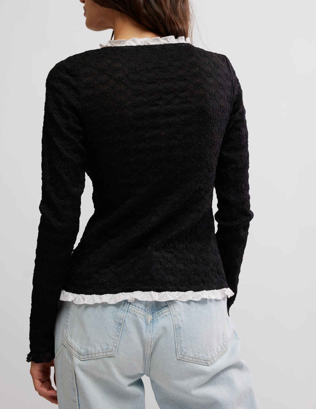 Women's black cardigan top with white buttons. From the brand Free People.