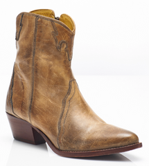 Women's western style boot from the brand Free People. The boot is the color tan.