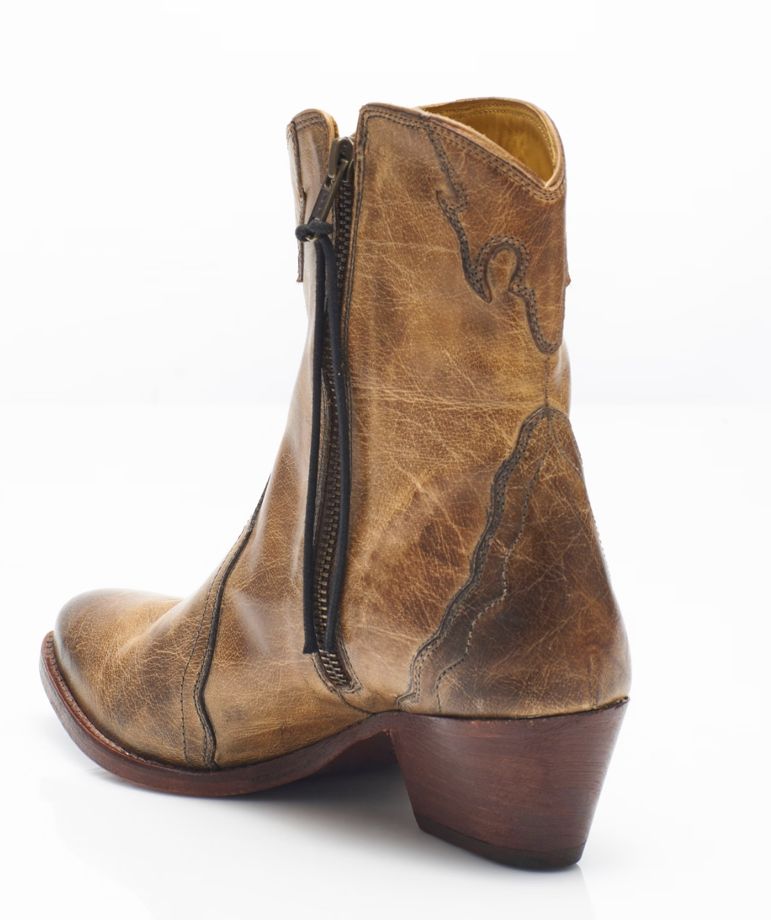 Women's western style boot from the brand Free People. The boot is the color tan.