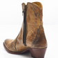Women's western style boot from the brand Free People. The boot is the color tan.