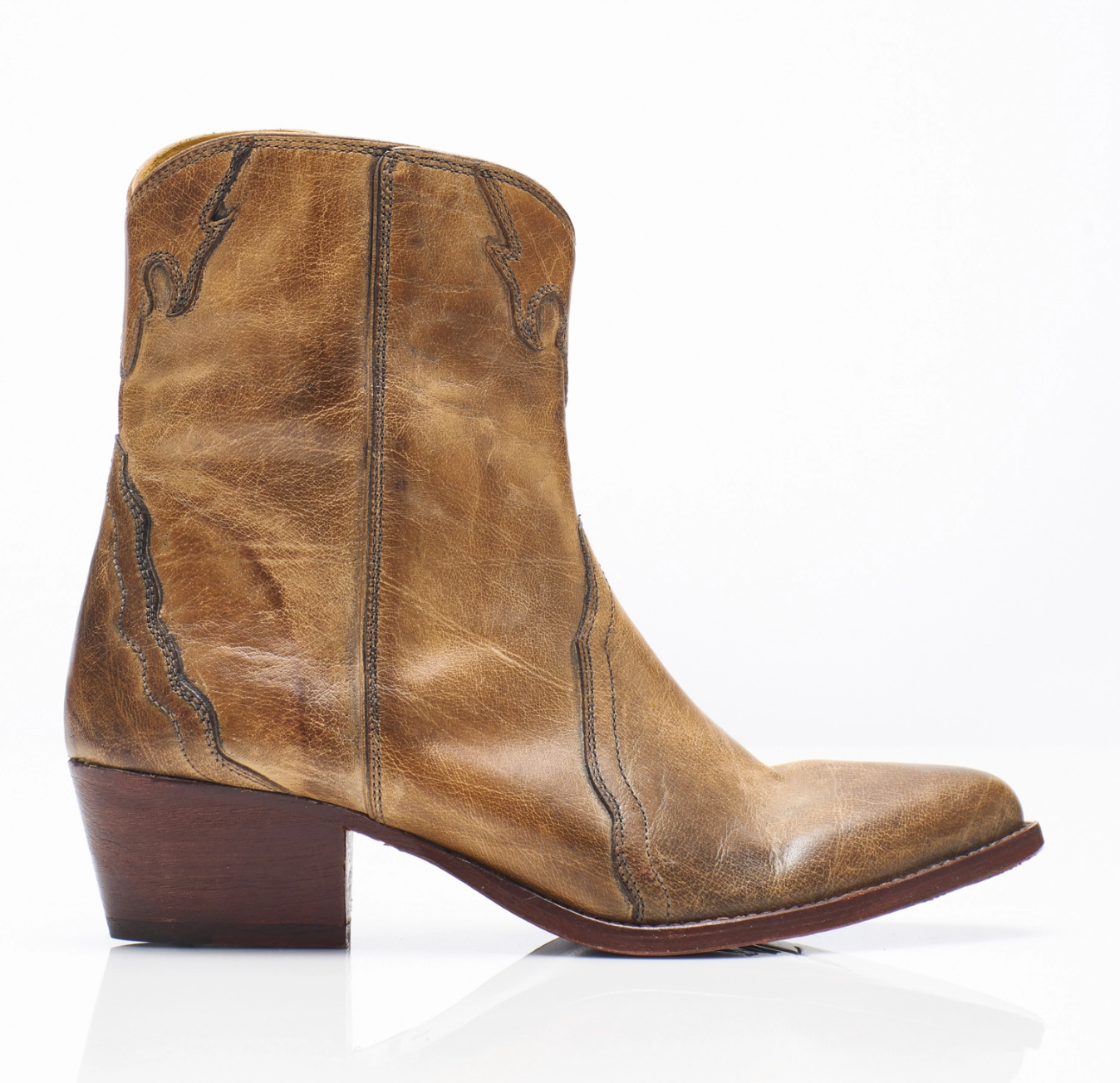 Women's western style boot from the brand Free People. The boot is the color tan.