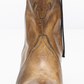 Women's western style boot from the brand Free People. The boot is the color tan.