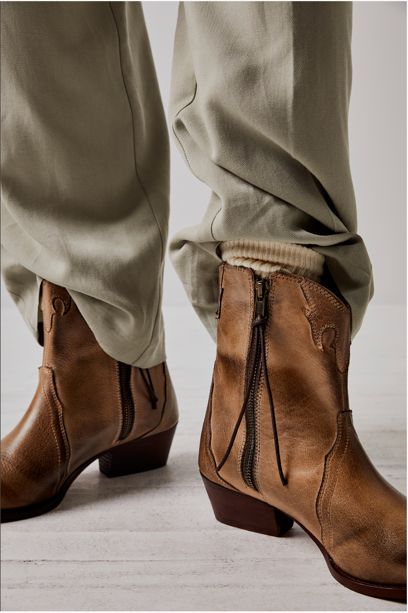 Women's western style boot from the brand Free People. The boot is the color tan.