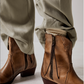Women's western style boot from the brand Free People. The boot is the color tan.