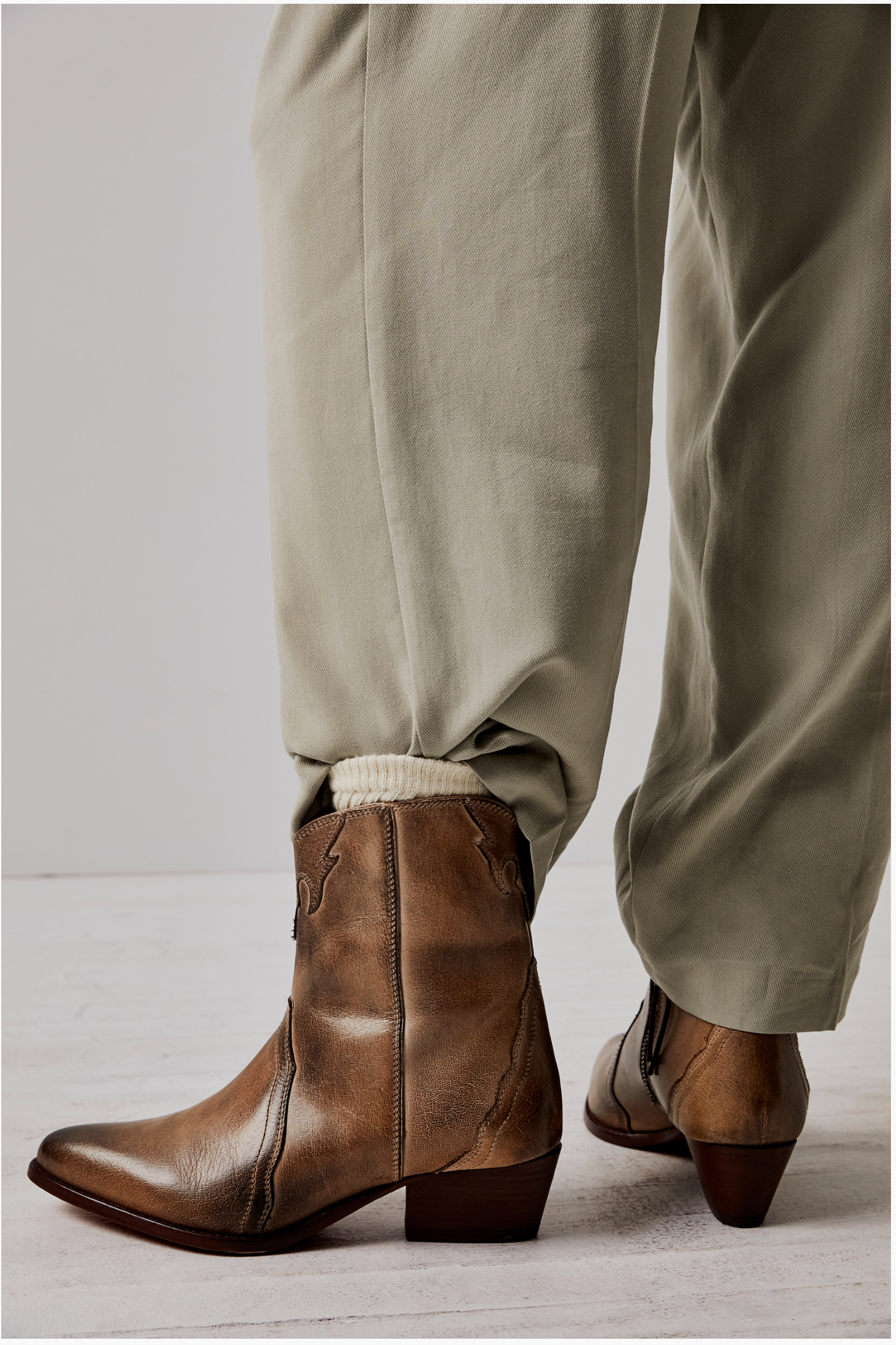 Women's western style boot from the brand Free People. The boot is the color tan.