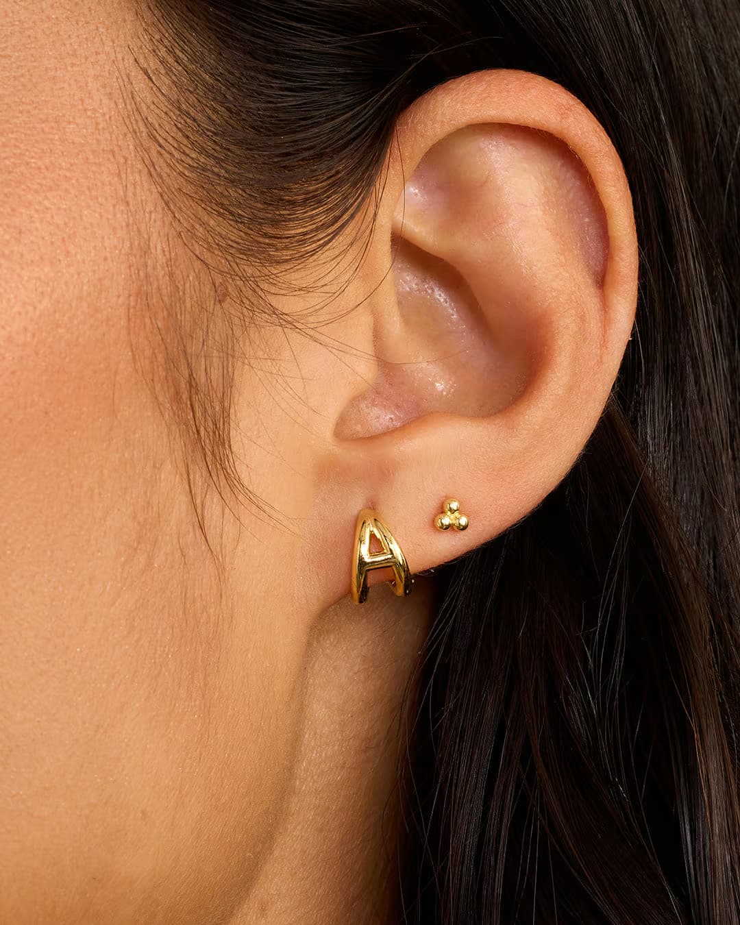 18k gold plated Initial A huggie earring from the jewelry brand Gorjana.