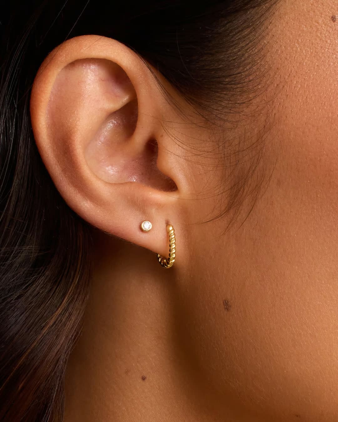 Single 18k gold huggie earring from the jewelry brand Gorjana.