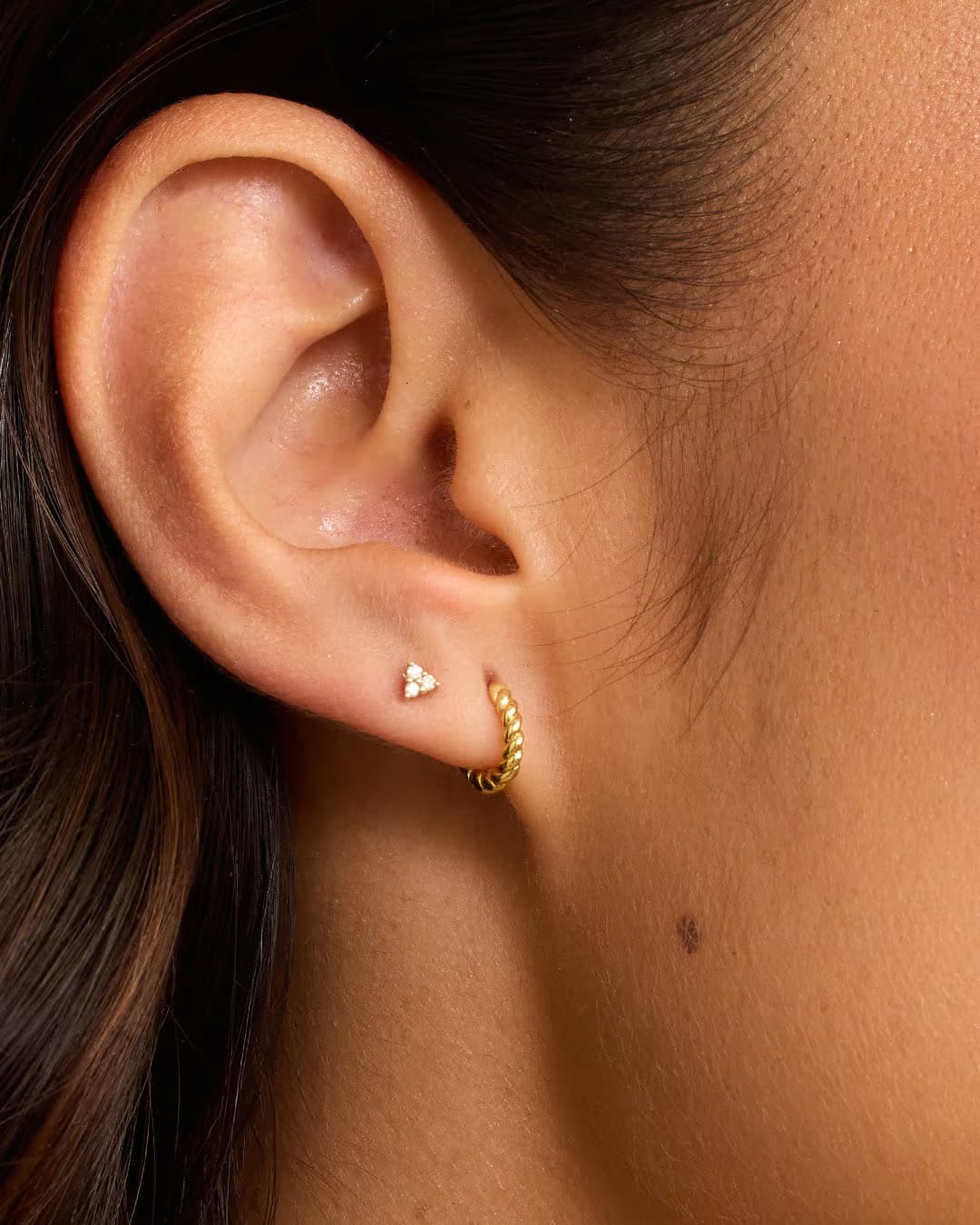 Single 18k gold huggie earring from the jewelry brand Gorjana.