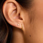 Single 18k gold huggie earring from the jewelry brand Gorjana.