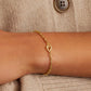 Gold chain bracelet with a mini heart closure from the brand of Gorjana. The gold is 18k gold plated.