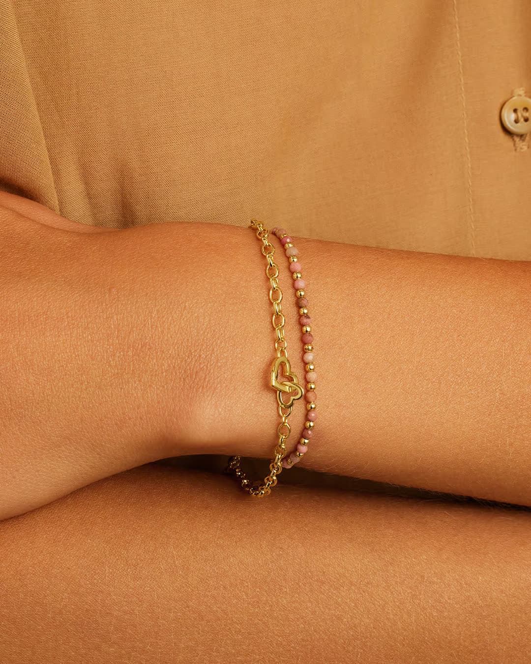 Gold chain bracelet with a mini heart closure from the brand of Gorjana. The gold is 18k gold plated.