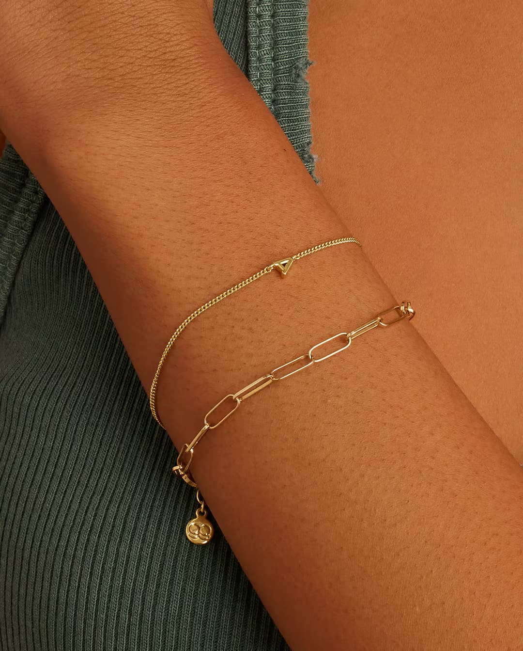 Adjustable gold bracelet with the letter A charm. The bracelet is from the jewelry brand Gorjana.