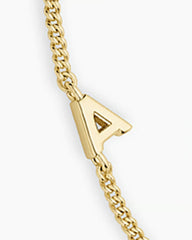 Adjustable gold bracelet with the letter A charm. The bracelet is from the jewelry brand Gorjana.