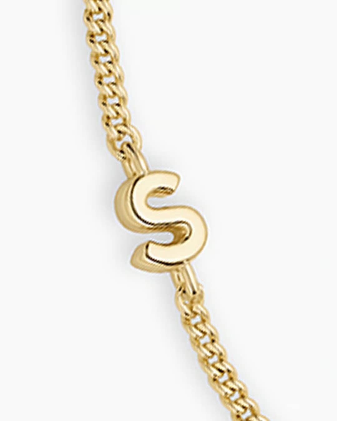 Adjustable gold bracelet with the letter S charm. The bracelet is from the jewelry brand Gorjana.