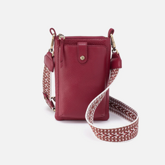 Cass Phone Crossbody in the color wine from the brand HOBO. The phone crossbody is made from pebbled leather.