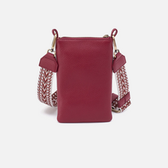 Cass Phone Crossbody in the color wine from the brand HOBO. The phone crossbody is made from pebbled leather.