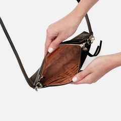 Darcy Crossbody bag designed out of polished leather in the color black. This crossbody is from the handbag brand HOBO.