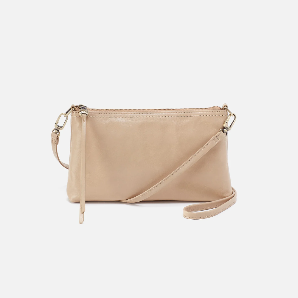 Darcy Crossbody bag designed out of polished leather in the color quartz. This crossbody is from the handbag brand HOBO.