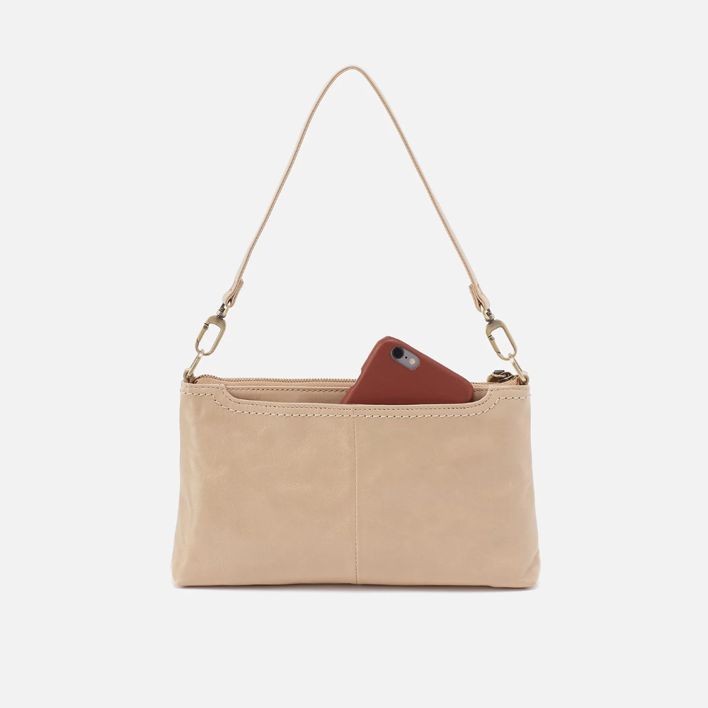 Darcy Crossbody bag designed out of polished leather in the color quartz. This crossbody is from the handbag brand HOBO.