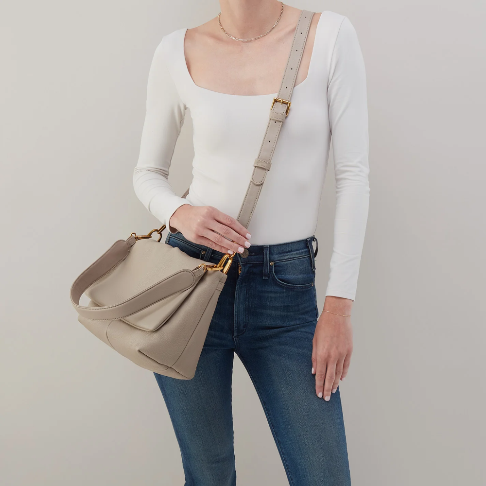 Harley Convertible Shoulder Bag in the color Taupe. The bag is designed from Pebbled leather from the brand HOBO.