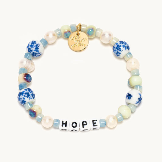 A white and blue beaded bracelet from Little Words project®. With beads that read "HOPE." 1400