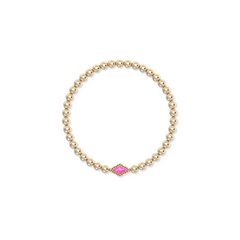 A gold beaded bracelet with stretch elastic with a Azalea Illusion. center. From Kendra Scott jewelry collection.