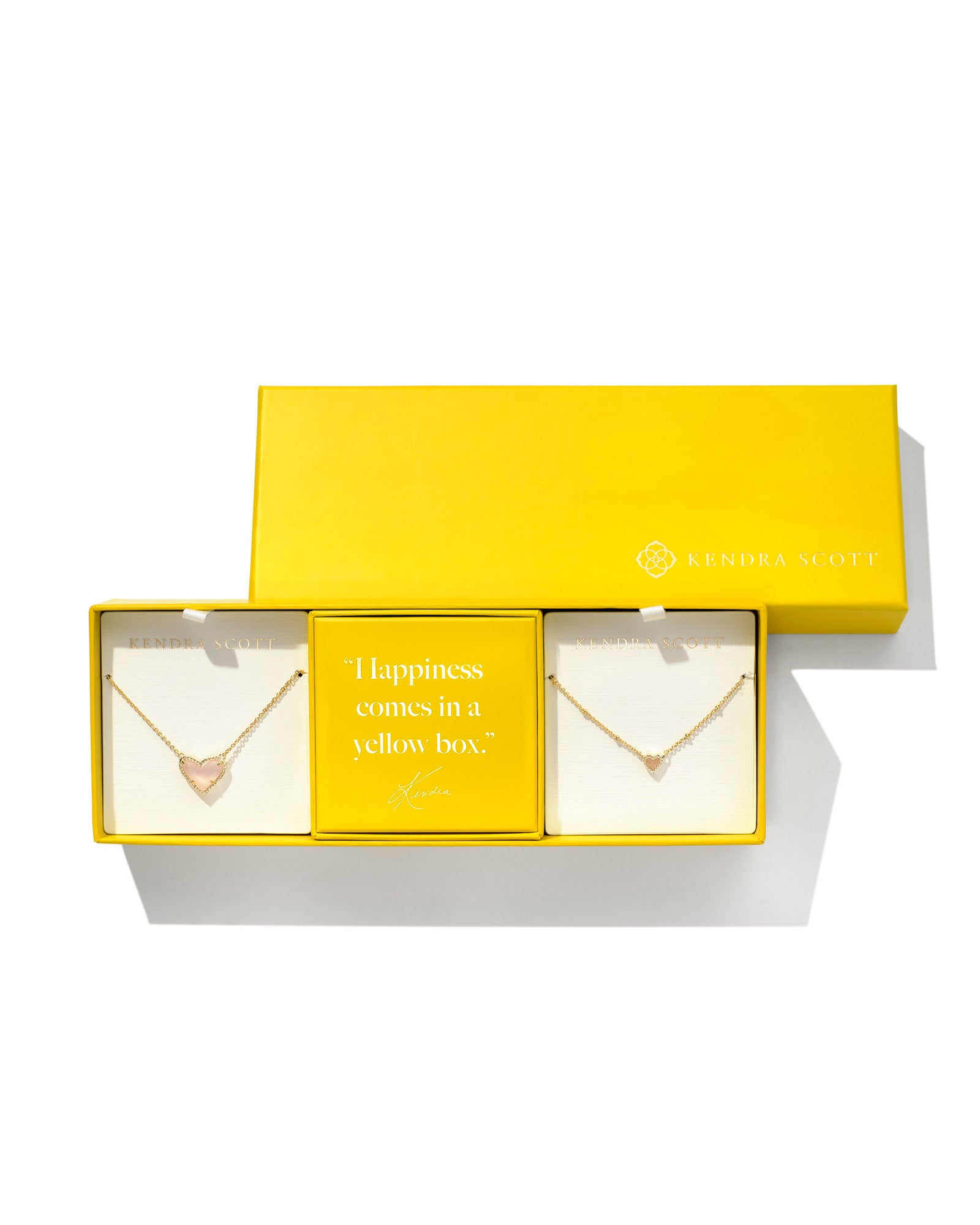 Ari Gift Set Of 2 - Gold Rose Quartz. With a box that reads, "Happiness comes in a yellow box. Kendra Scott."