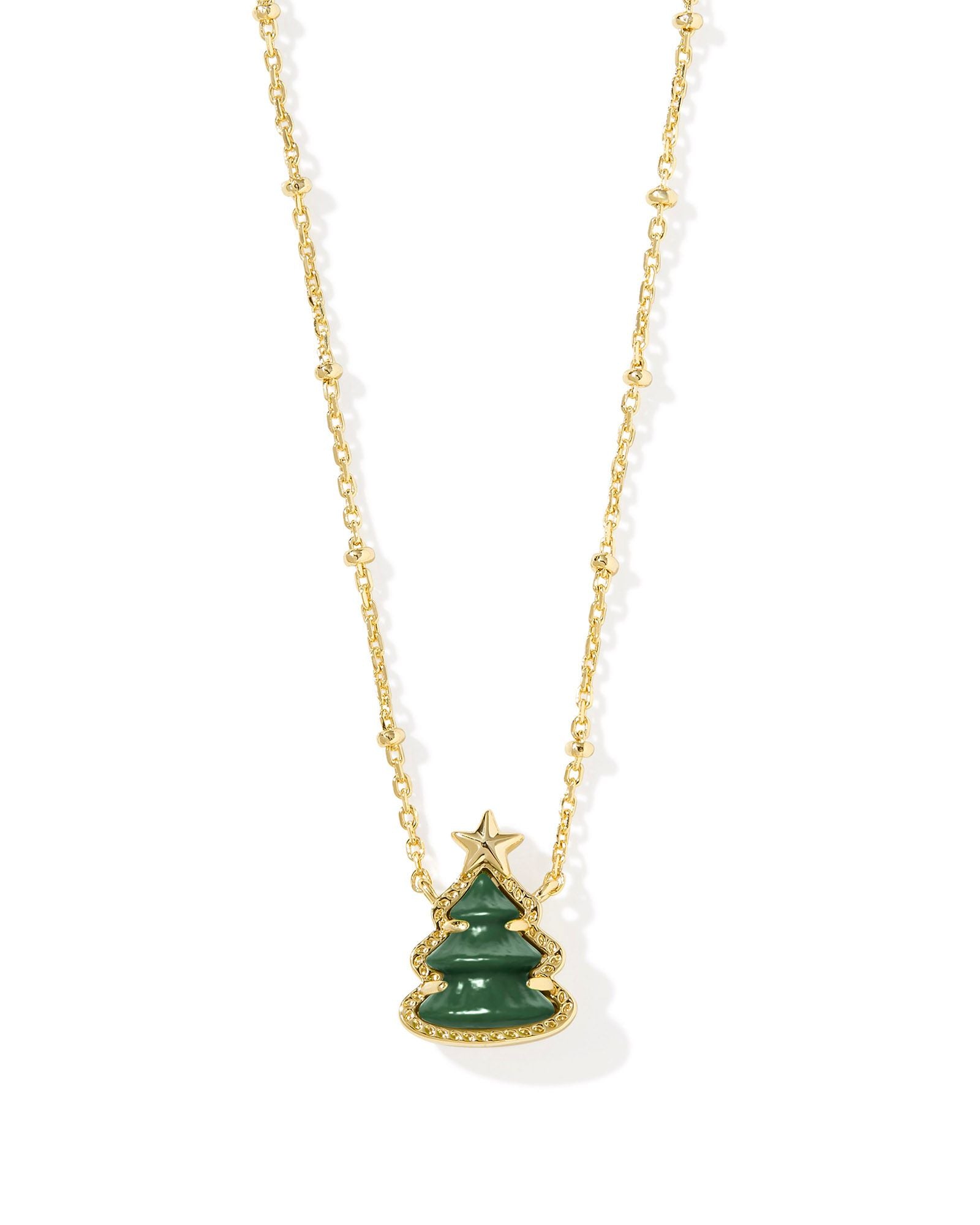 Kendra Scott gold necklace with a Christmas tree pendant.