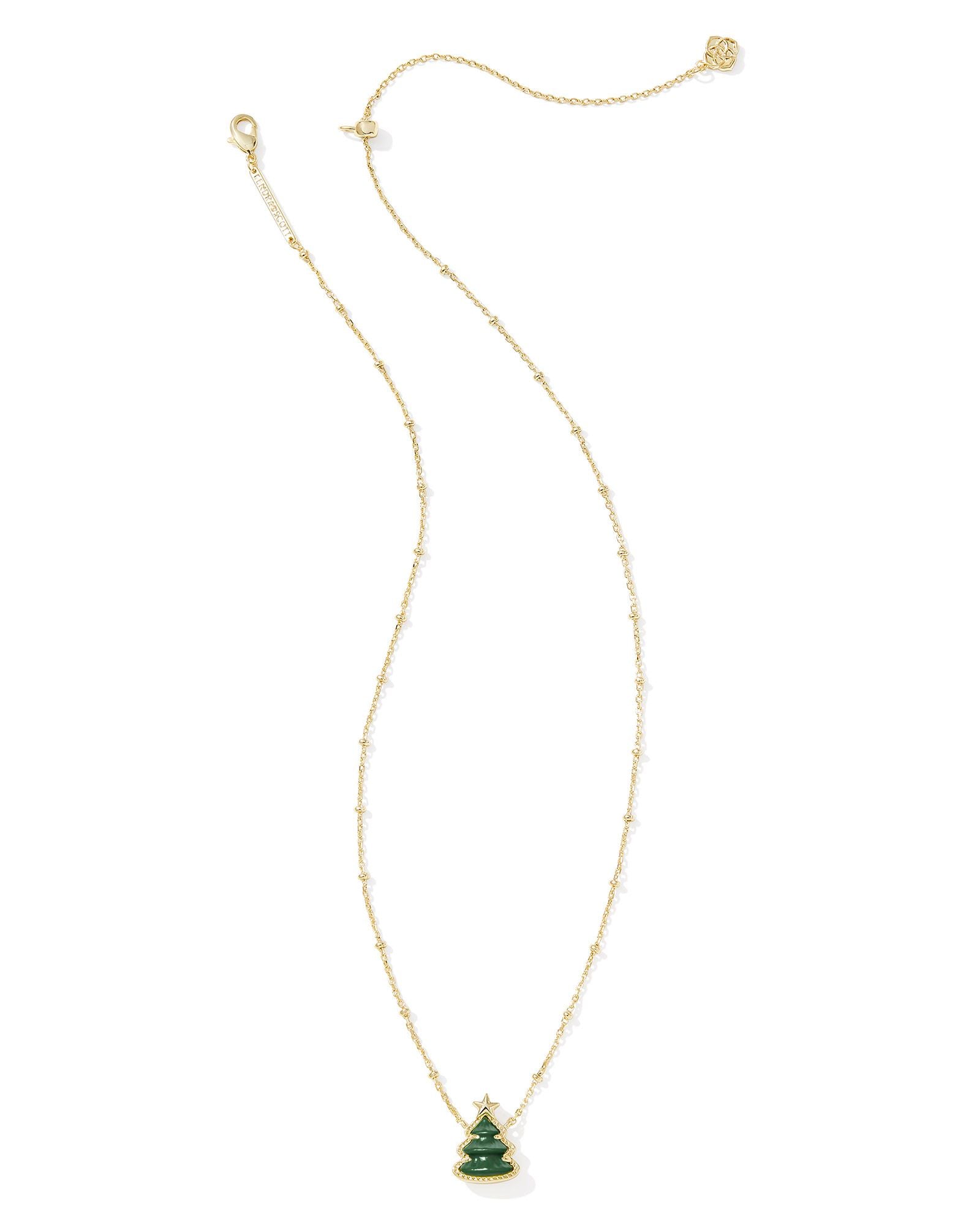 Kendra Scott gold necklace with a Christmas tree pendant.