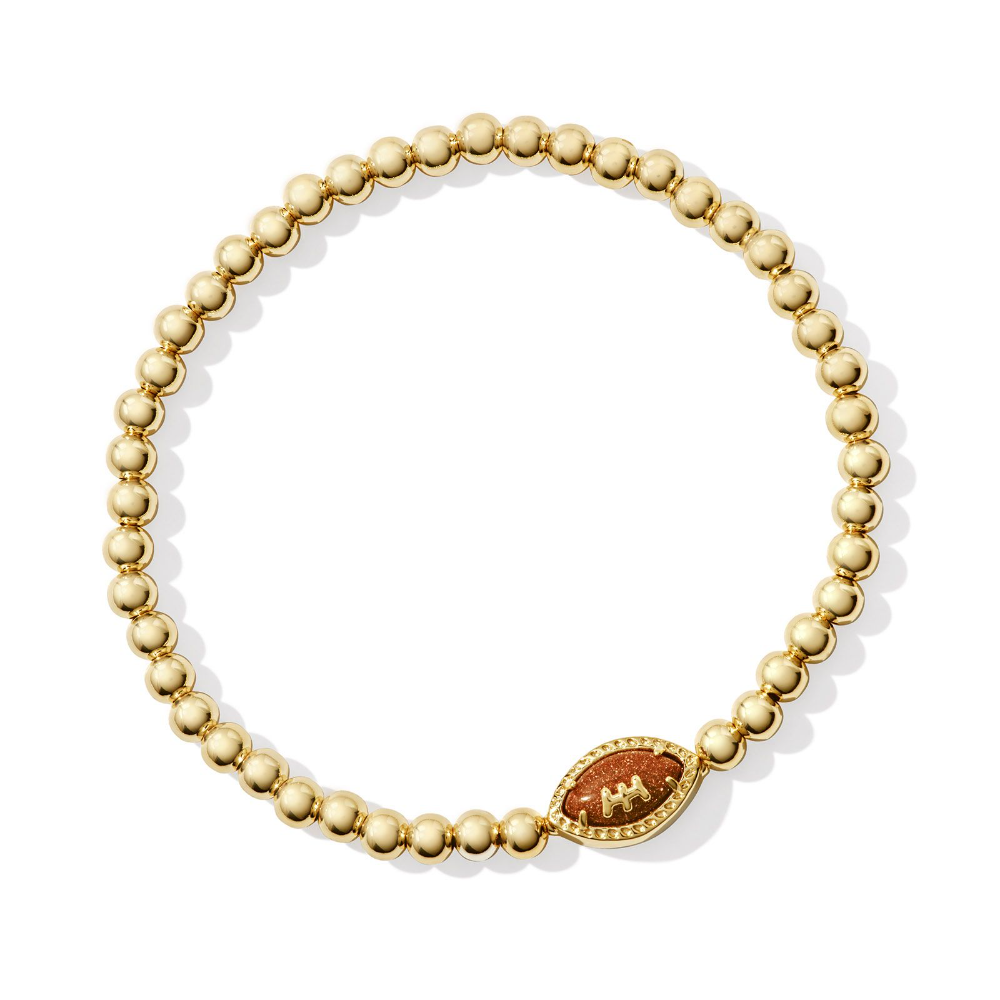 Gold colored stretch bracelet from Kendra Scott with a football pendant.