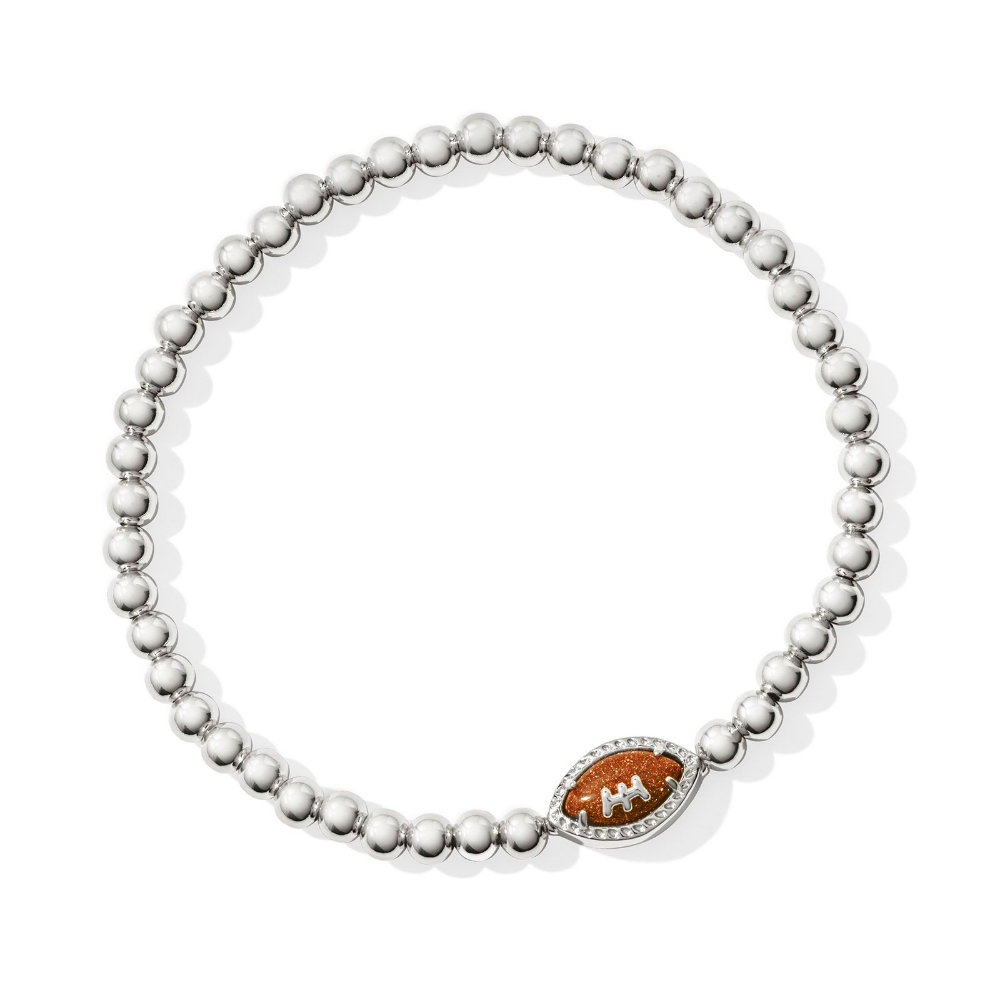 Silver colored stretch bracelet from Kendra Scott with a football pendant.