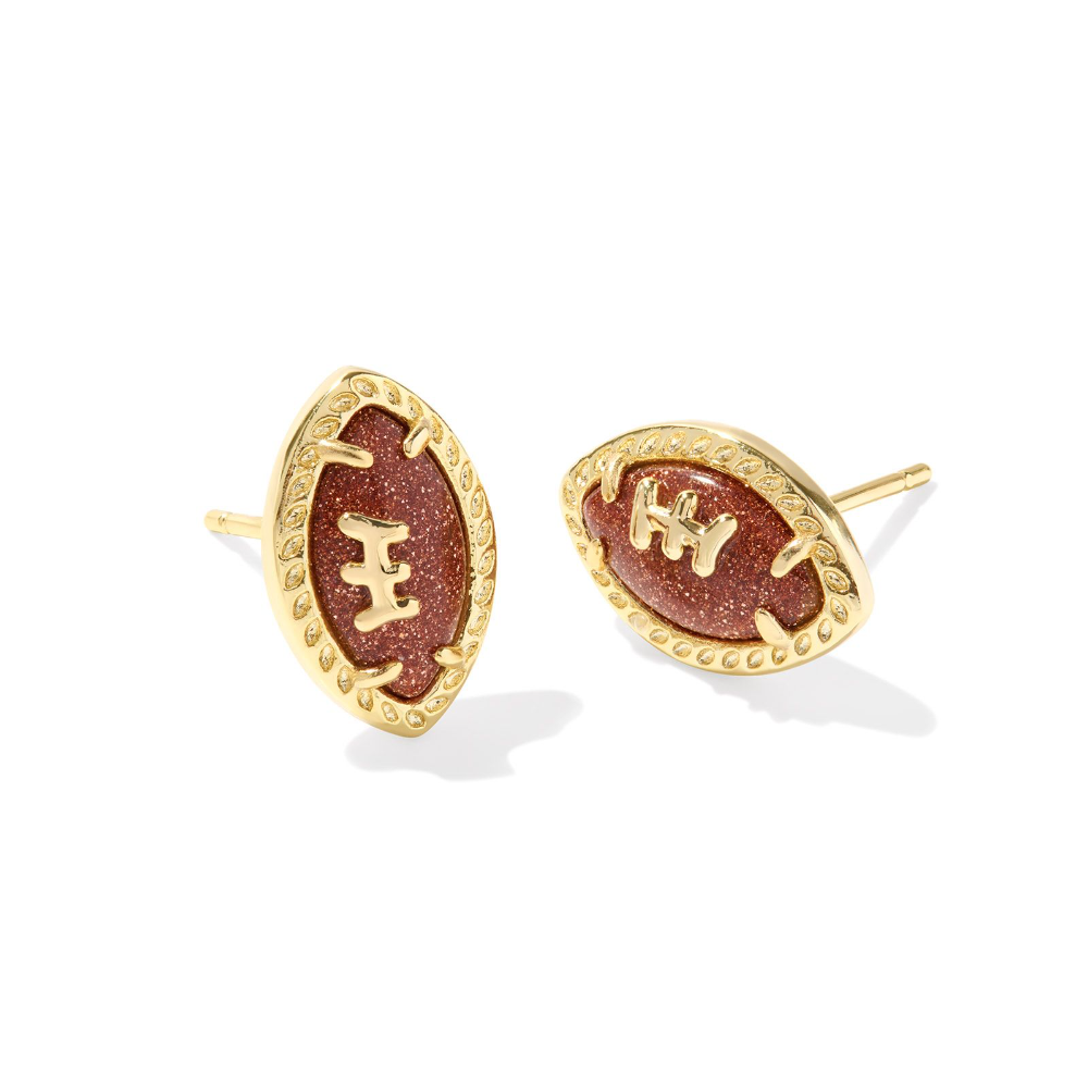 Gold colored stud earrings in the shape of footballs, designed by Kendra Scott.