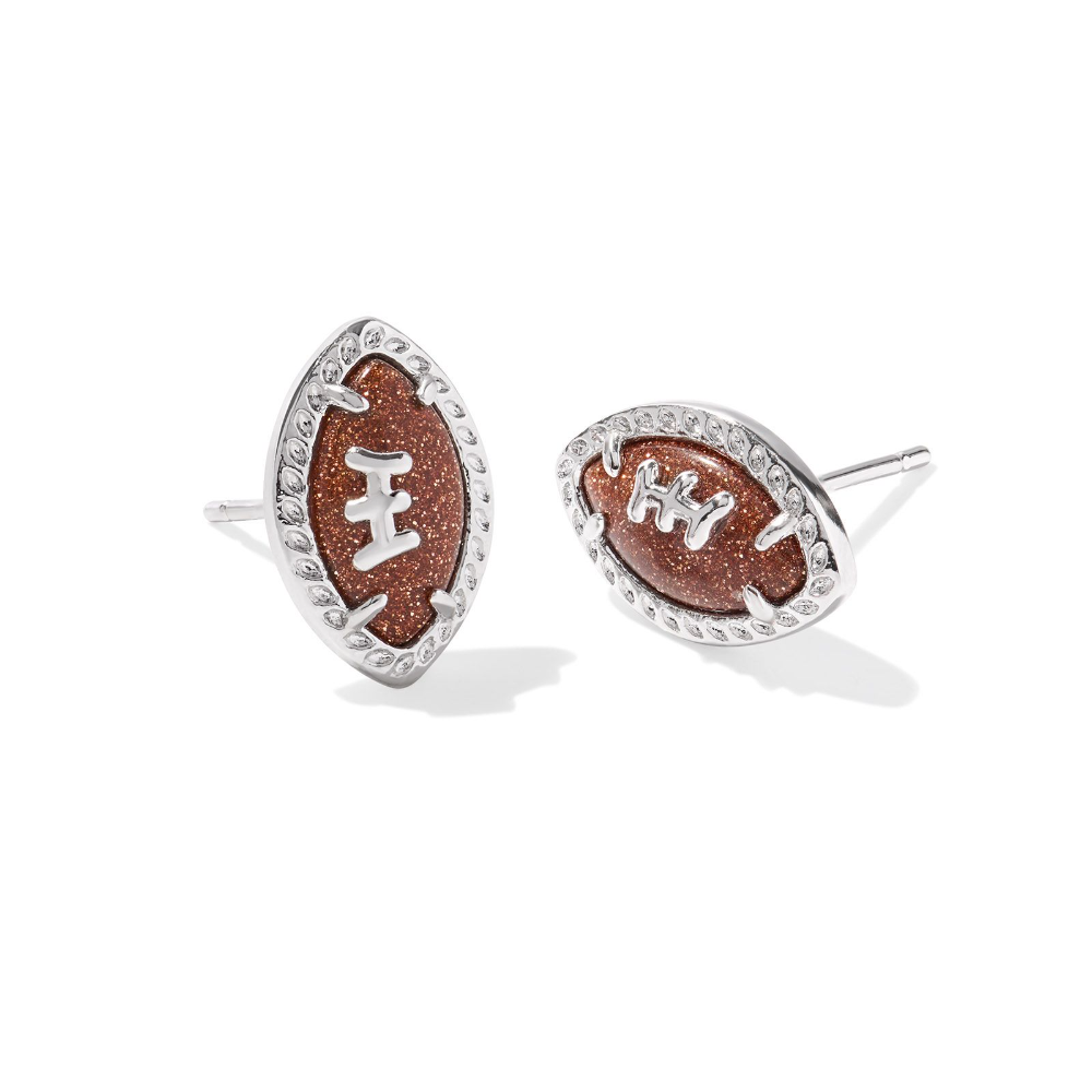 Silver colored stud earrings in the shape of footballs, designed by Kendra Scott.