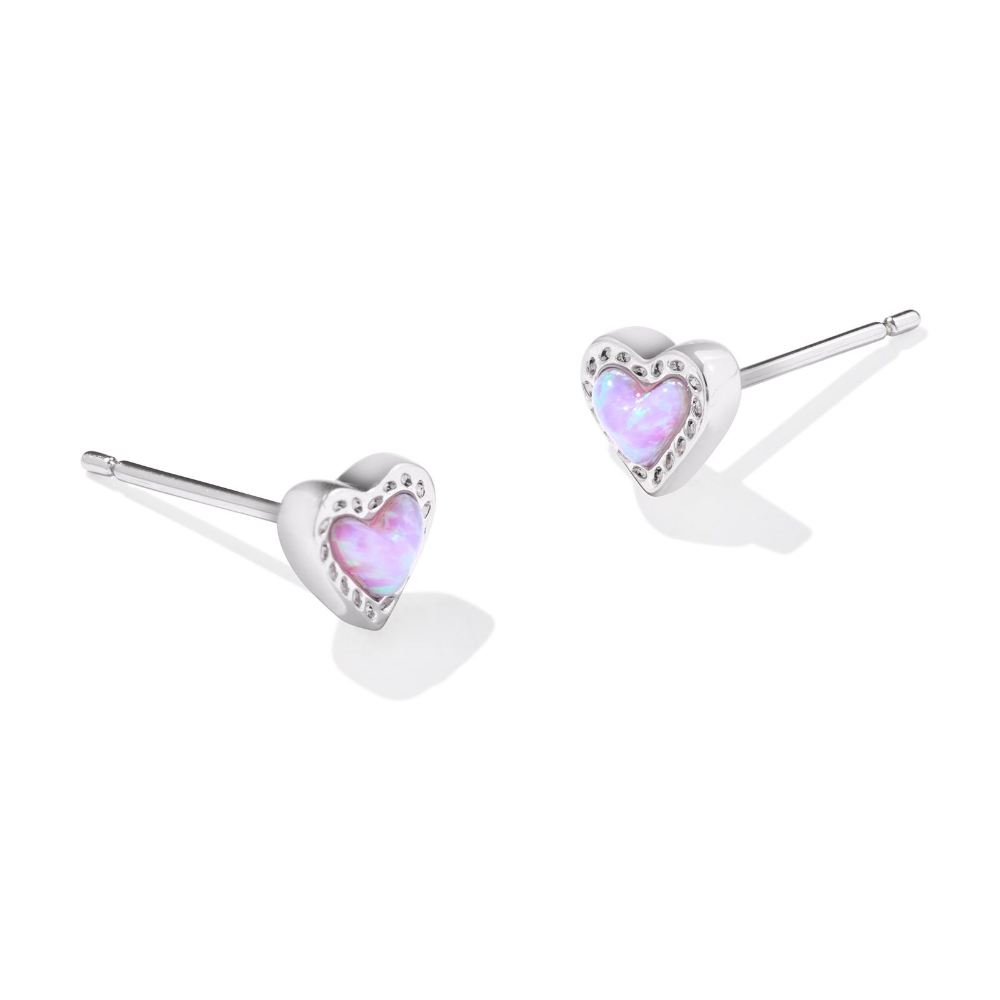 Silver heart shape stud earrings with a purple charm in the middle, from the jewelry brand Kendra Scott.