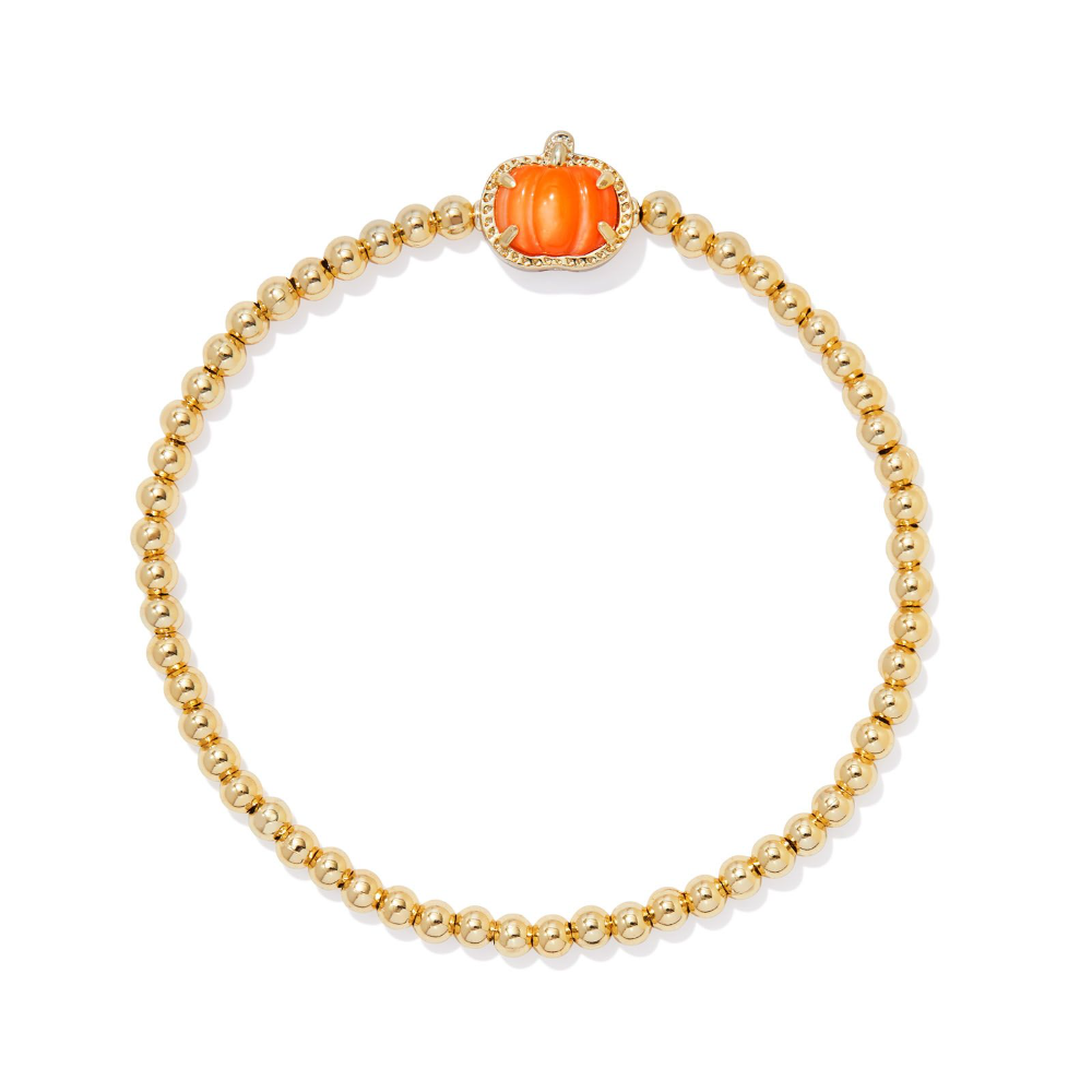 A Halloween themed pumpkin stretch bracelet from Kendra Scott. An orange charm, with a gold bead bracelet.