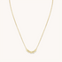 A gold chain necklace from Little Words Project. The necklace includes gold beads that read, TRUST.