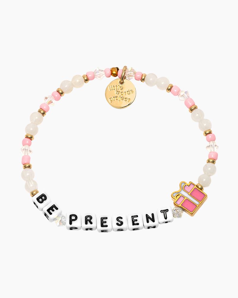 Beaded bracelet in white and pink, with the phrase "Be Present" with a gift wrapped present charm.