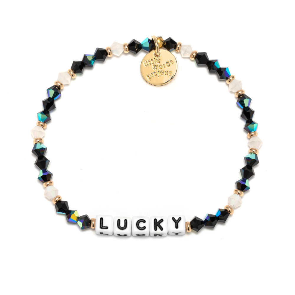 A beaded bracelet that reads, LUCKY. Designed by Little Words Project.