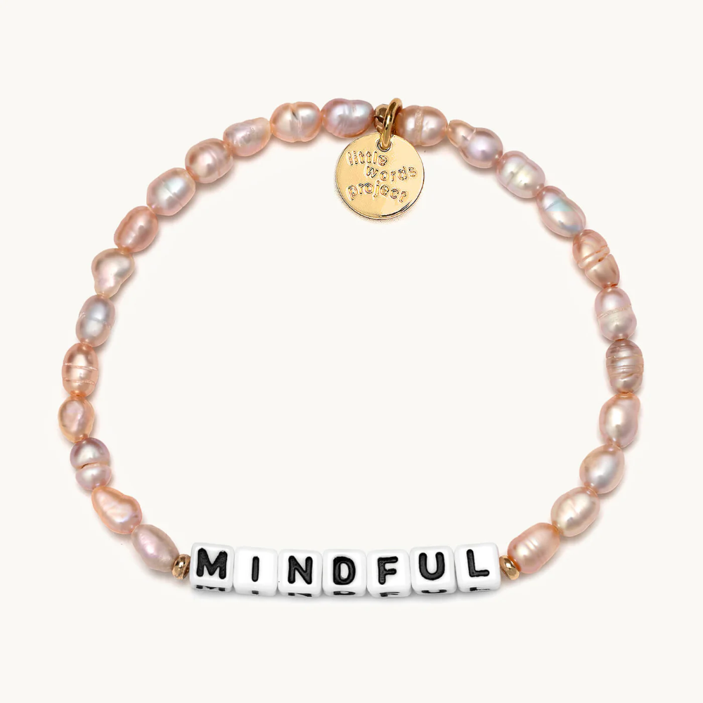 A bead bracelet from Little Words Project that reads, Mindful. Designed from freshwater pearls.