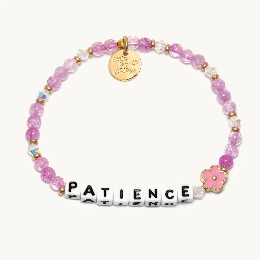 A purple beaded bracelet from Little Words Project that reads, PATIENCE.