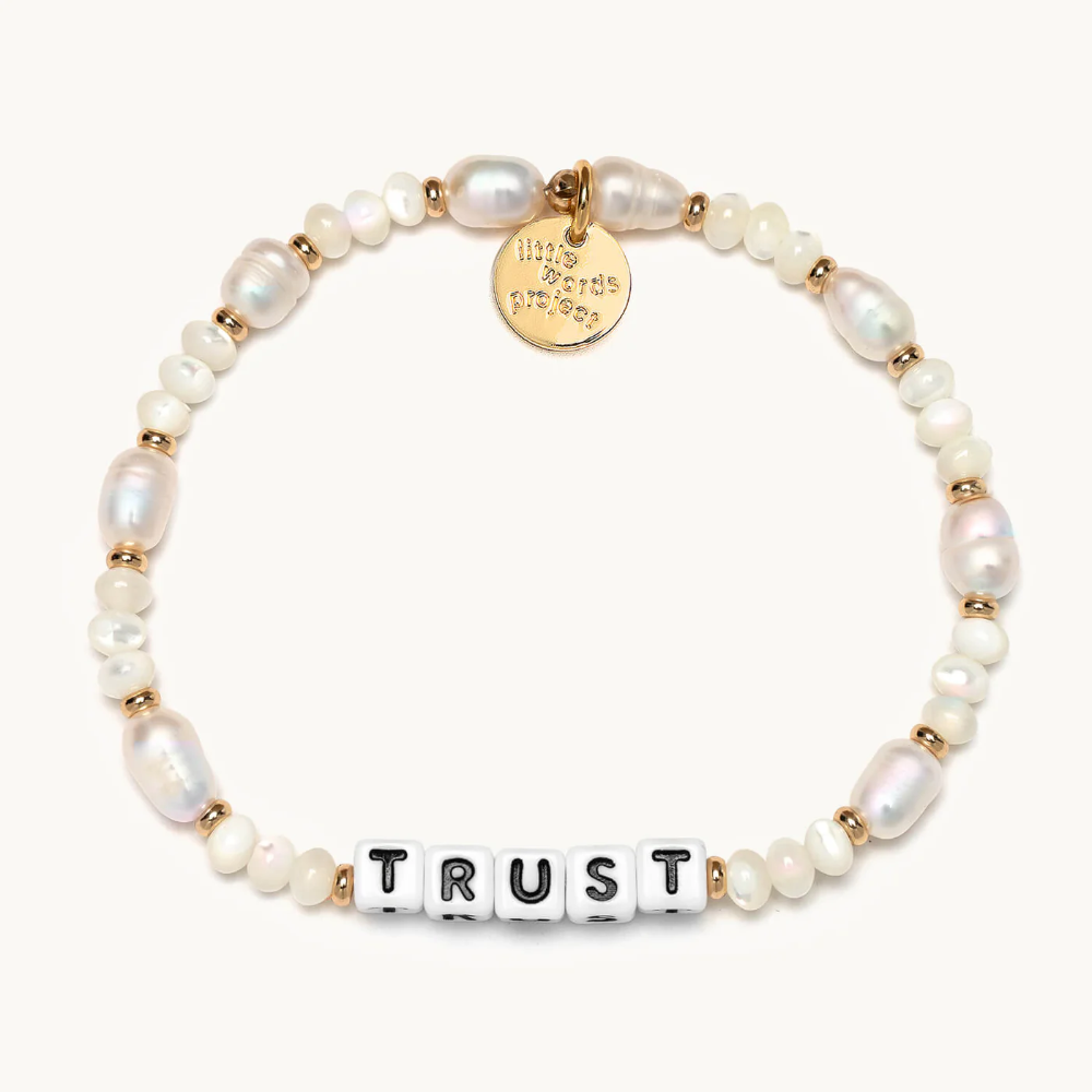 Hand-crafted, freshwater pearl beaded bracelet from Little Words Project. The bracelet reads, TRUST.