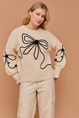 Long Sleeve Crew Neck Ribbon Sweater Top in the color cream.