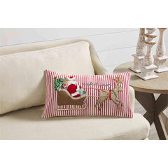 A Mud Pie pillow with Santa Claus and a reindeer.