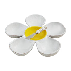 A white Daisy chip platter with a yellow middle for the dip, and knife on top.