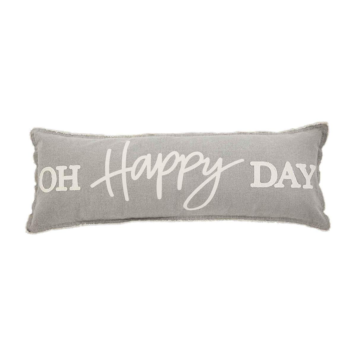 A long grey pillow that reads "Oh Happy Day" in white font.