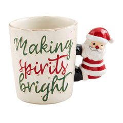 A coffee mug that reads "Making Sprits Bright" with Santa Clause as the handle.