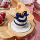 White and blue Christmas ornament from Nora Fleming.