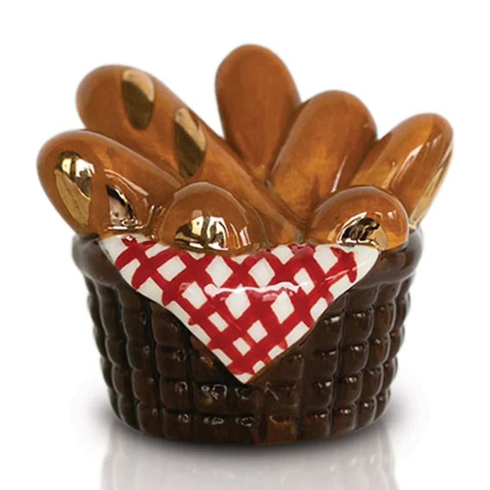 A Nora Fleming Mini Ornament designed as a classic breadstick basket.
