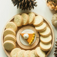 A Nora Fleming Maple Cracker Round.